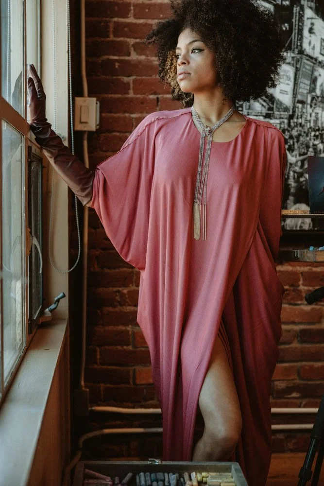 Model in an art gallery for an editorial fashion shoot with tourmaline jewelry