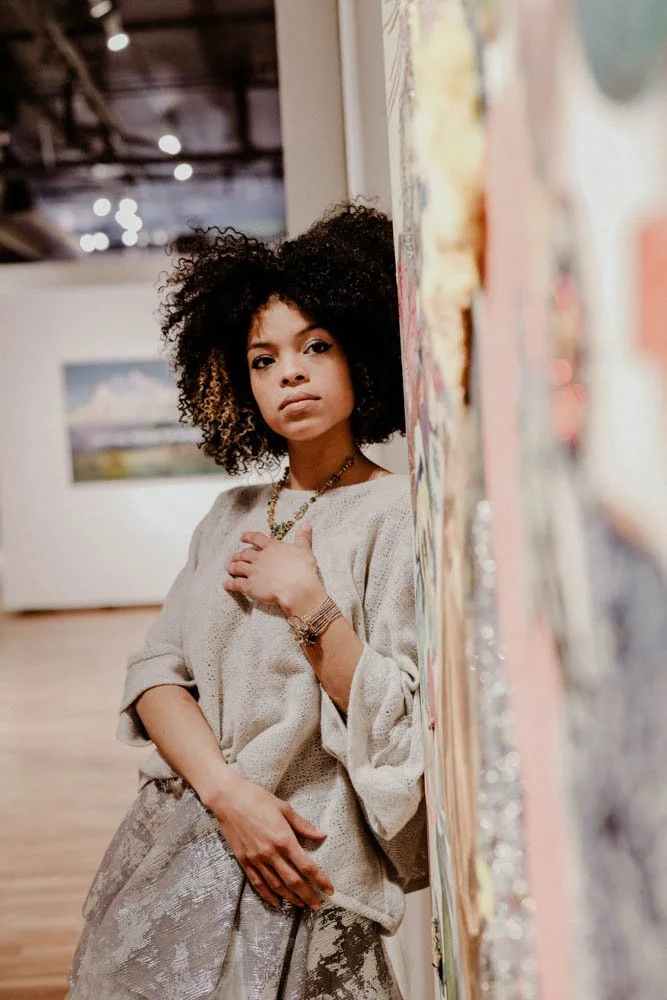 Model in an art gallery for an editorial fashion shoot with tourmaline jewelry