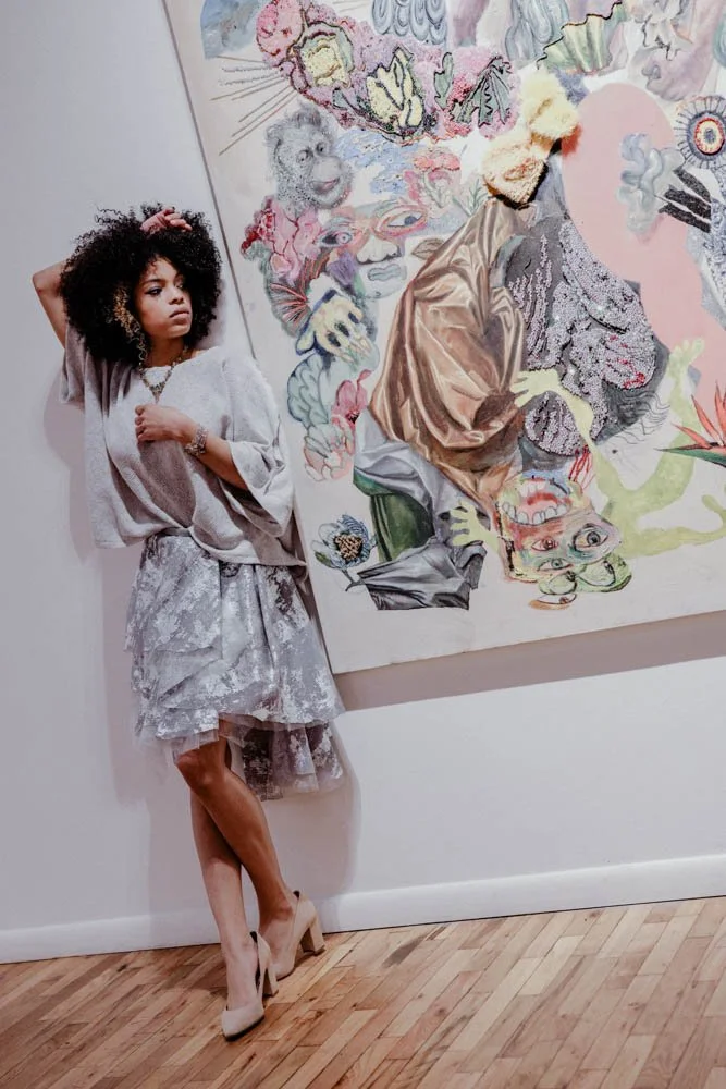 Model in an art gallery for an editorial fashion shoot with tourmaline jewelry