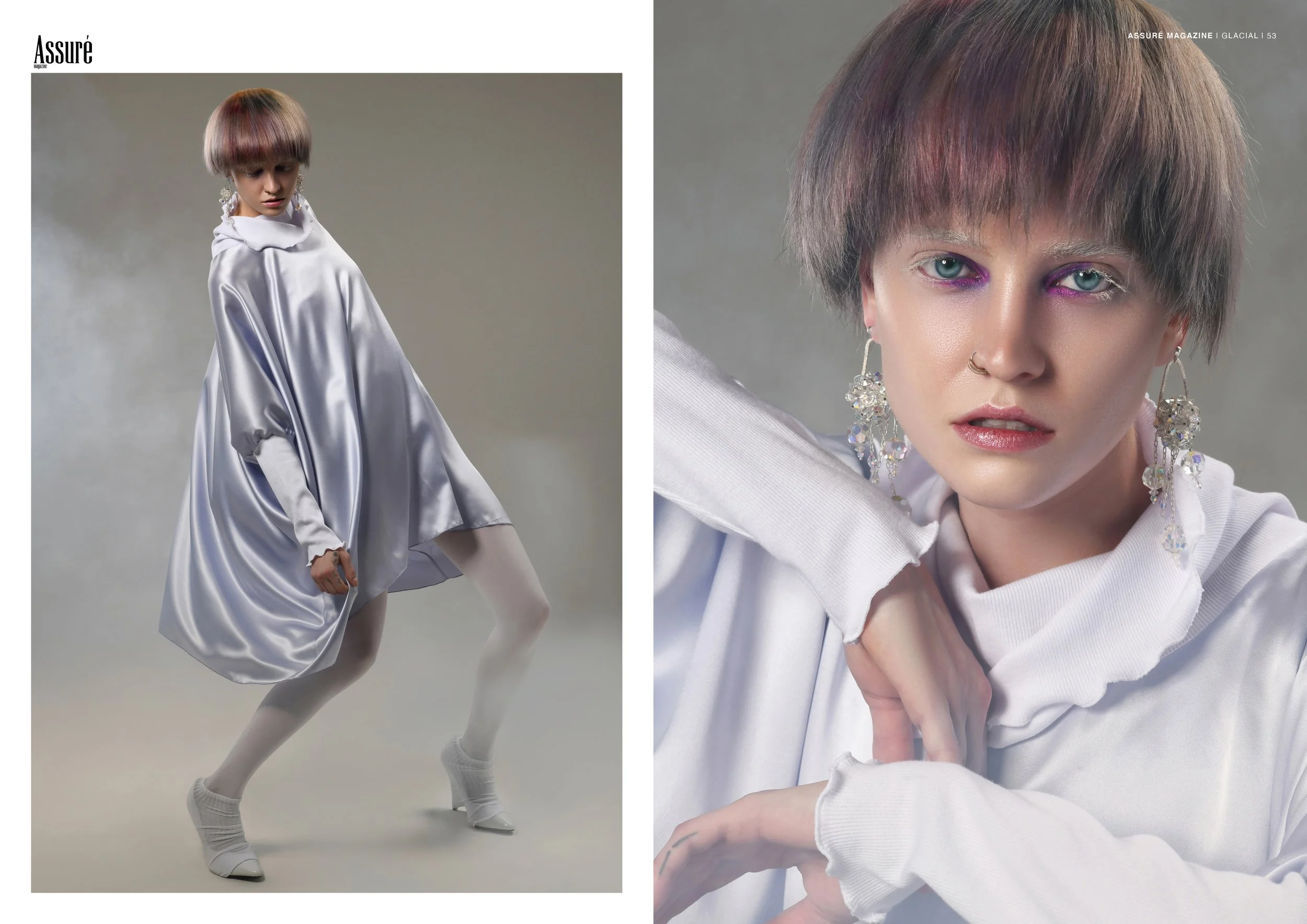 Fashion editorial featuring a model in a flowing silver-white dress, crystal earrings, cropped bowl cut, and vivid pink eye makeup.