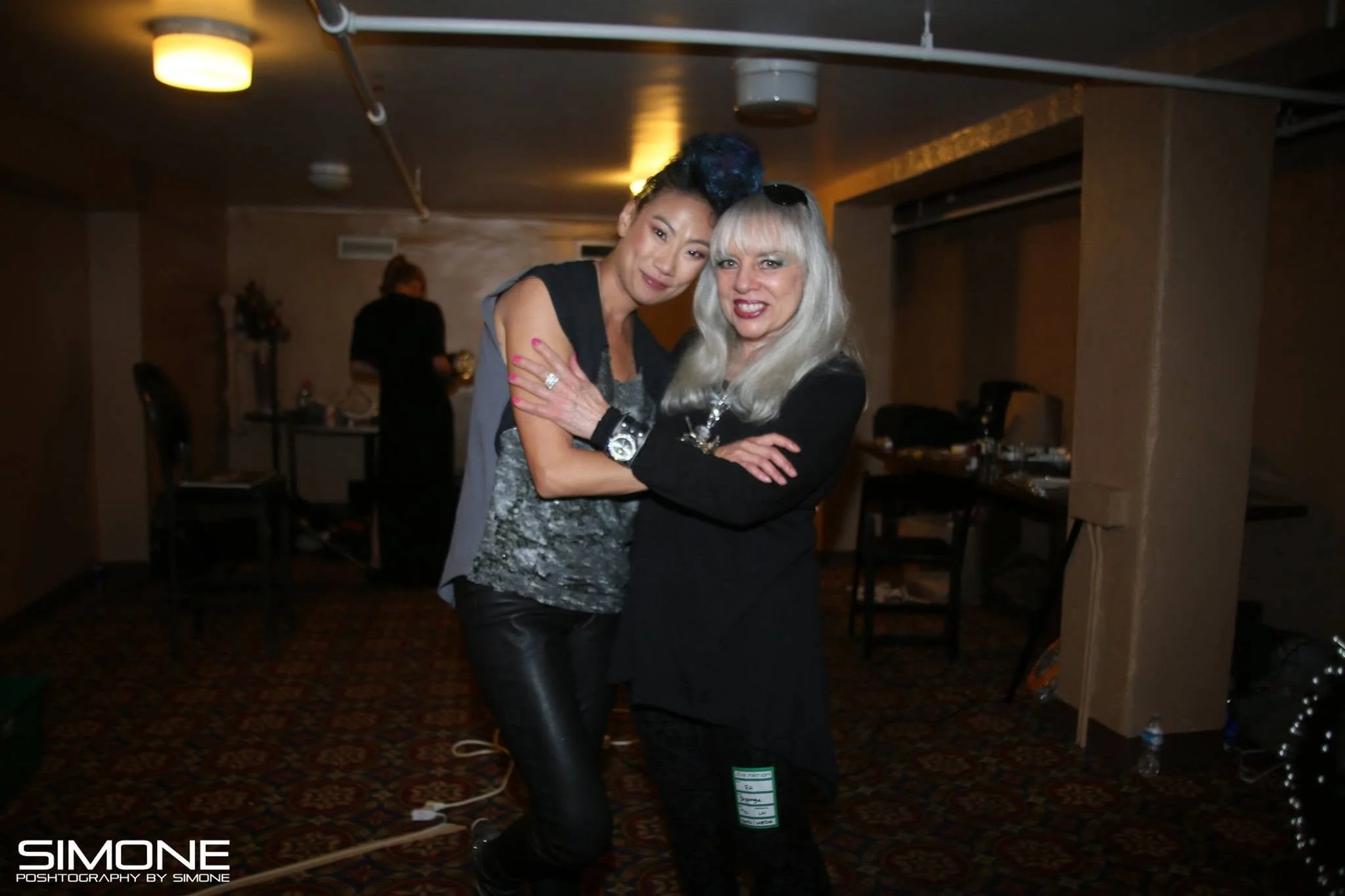 Backstage prepping for the fashion show with statement jewelry models, artists, hair and makeup artists