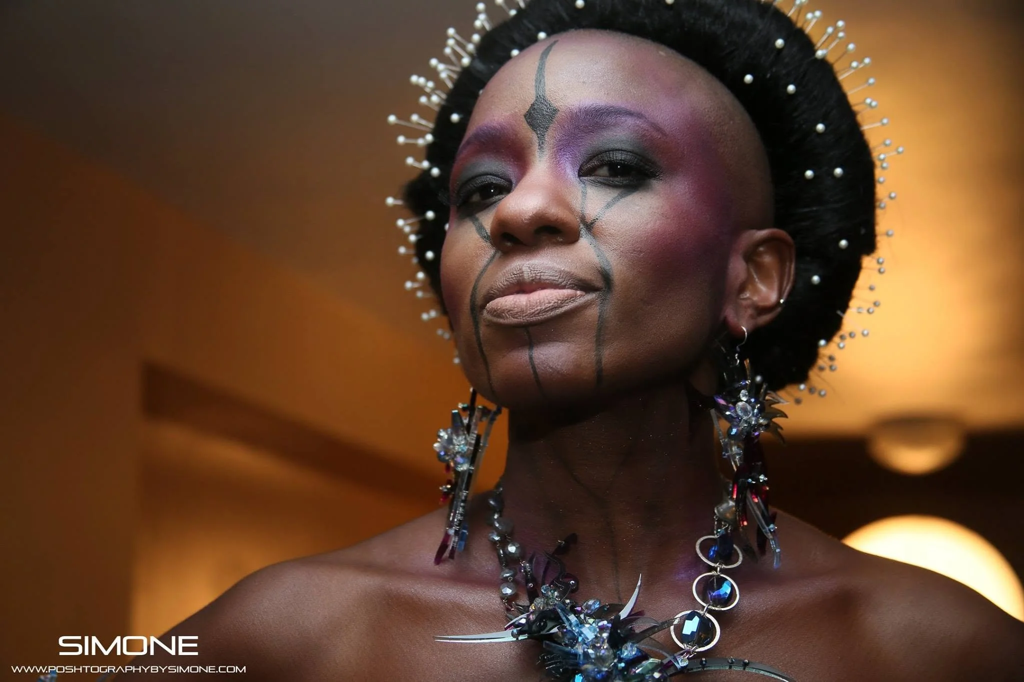 Backstage prepping for the fashion show with statement jewelry models, artists, hair and makeup artists