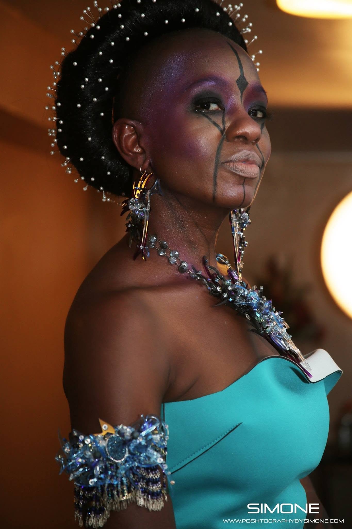 Backstage prepping for the fashion show with statement jewelry models, artists, hair and makeup artists