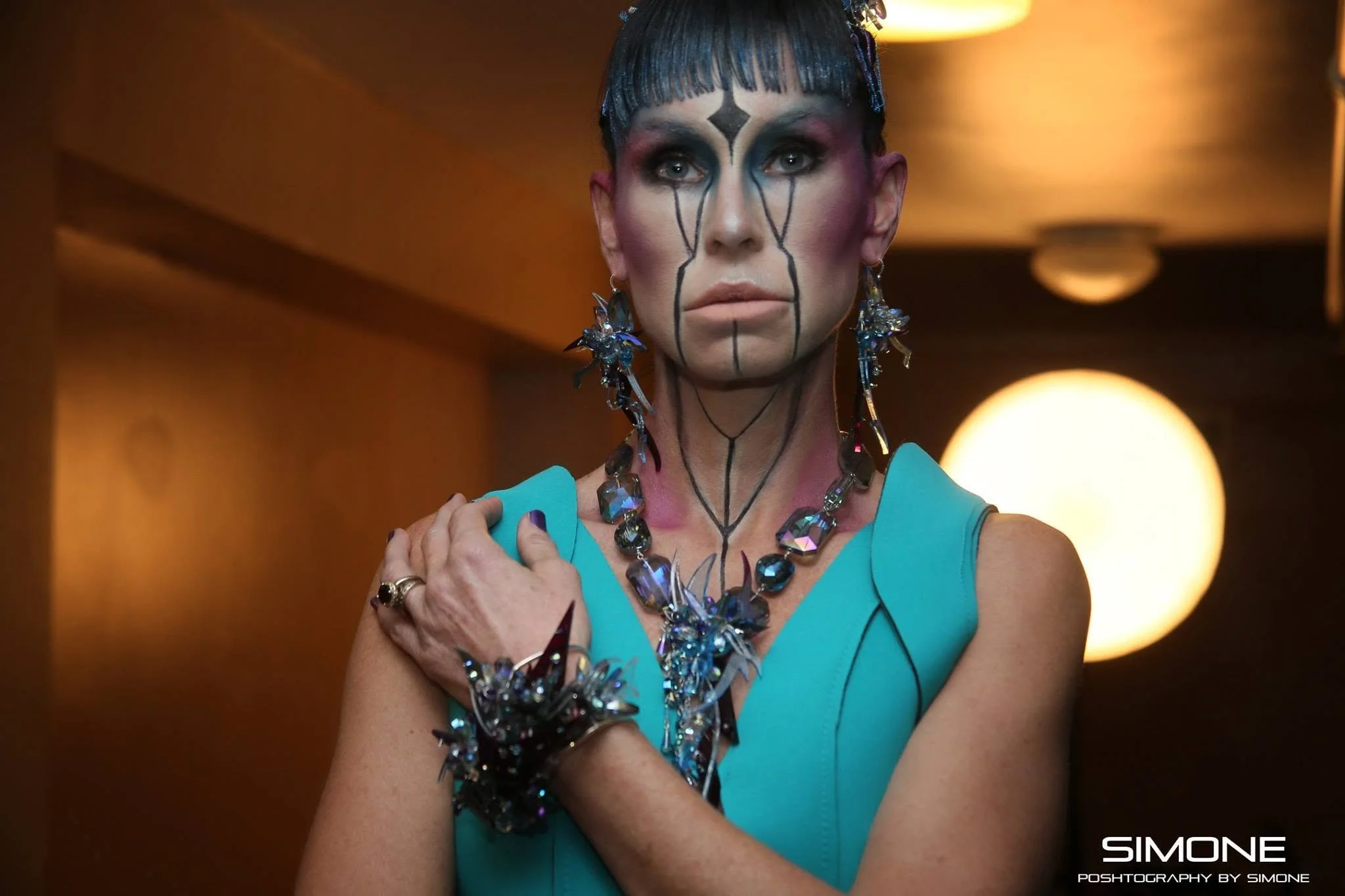 Backstage prepping for the fashion show with statement jewelry models, artists, hair and makeup artists