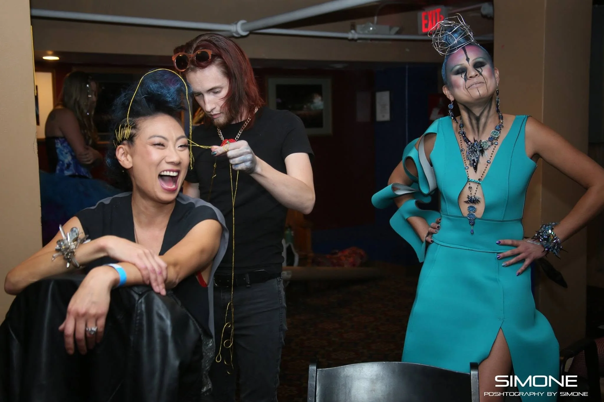 Backstage prepping for the fashion show with statement jewelry models, artists, hair and makeup artists