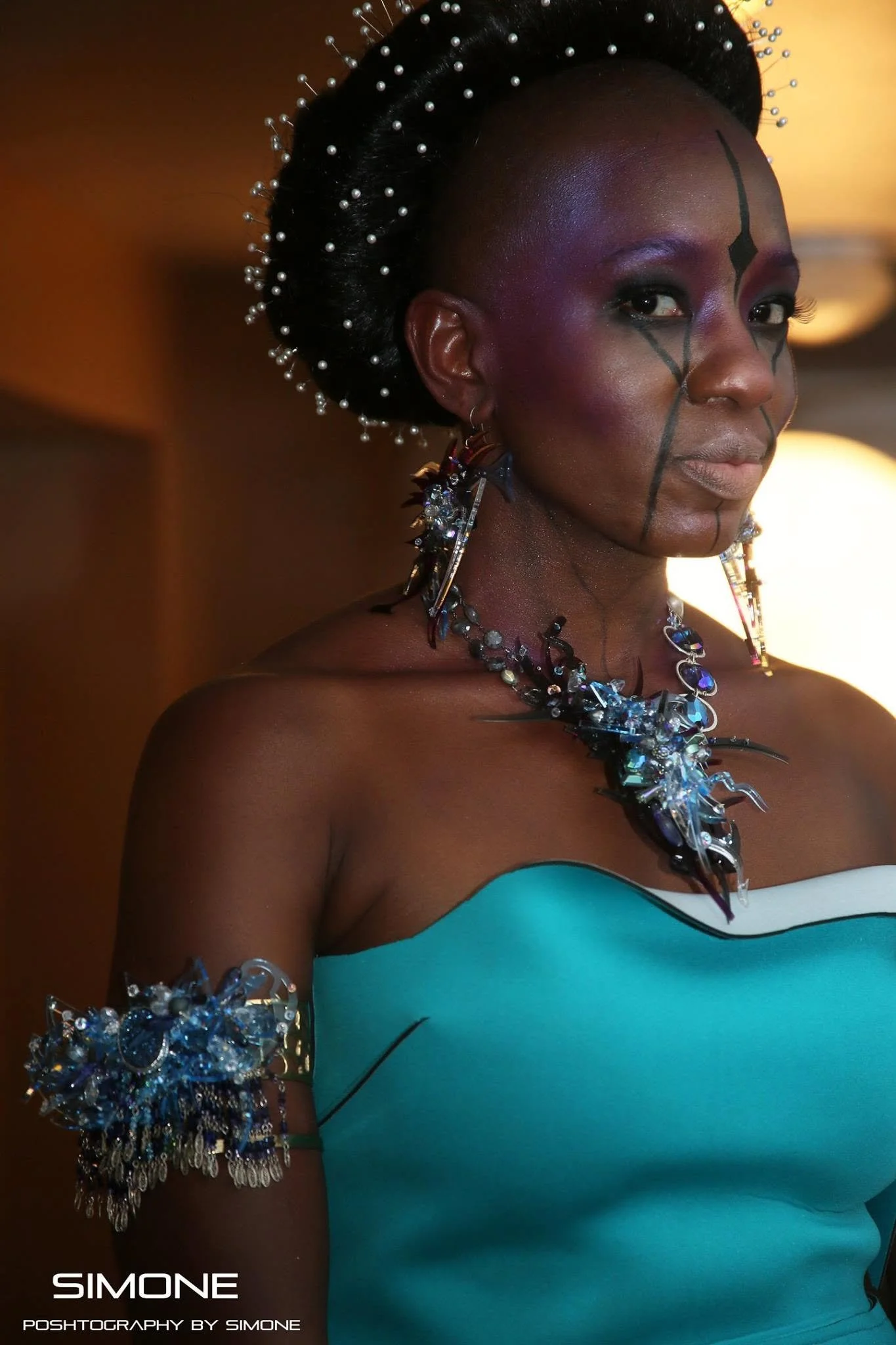Backstage prepping for the fashion show with statement jewelry models, artists, hair and makeup artists