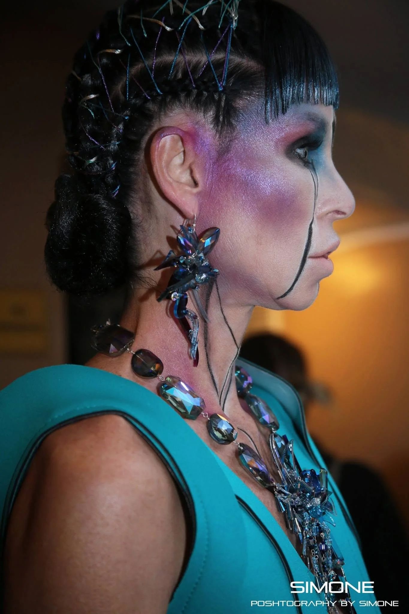 Backstage prepping for the fashion show with statement jewelry models, artists, hair and makeup artists