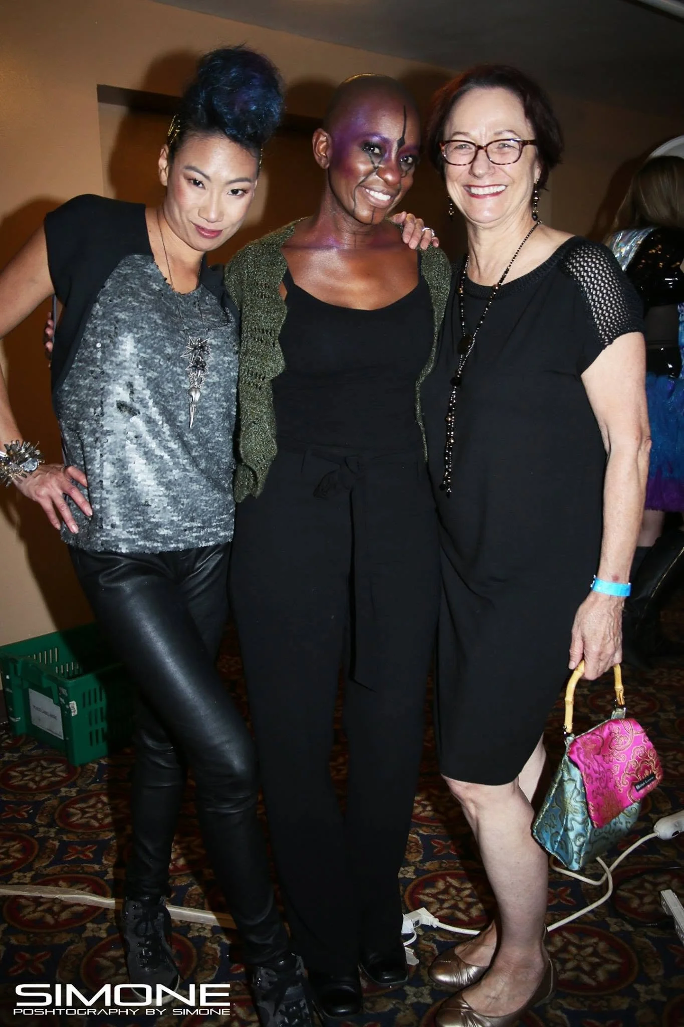 Backstage prepping for the fashion show with statement jewelry models, artists, hair and makeup artists