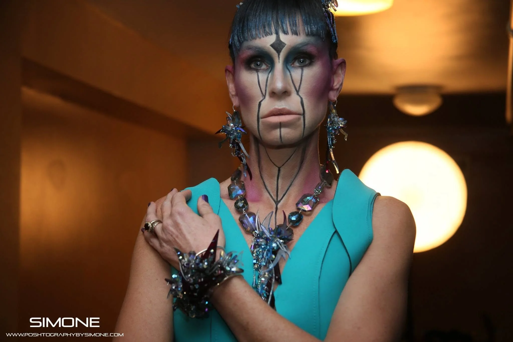 Backstage prepping for the fashion show with statement jewelry models, artists, hair and makeup artists