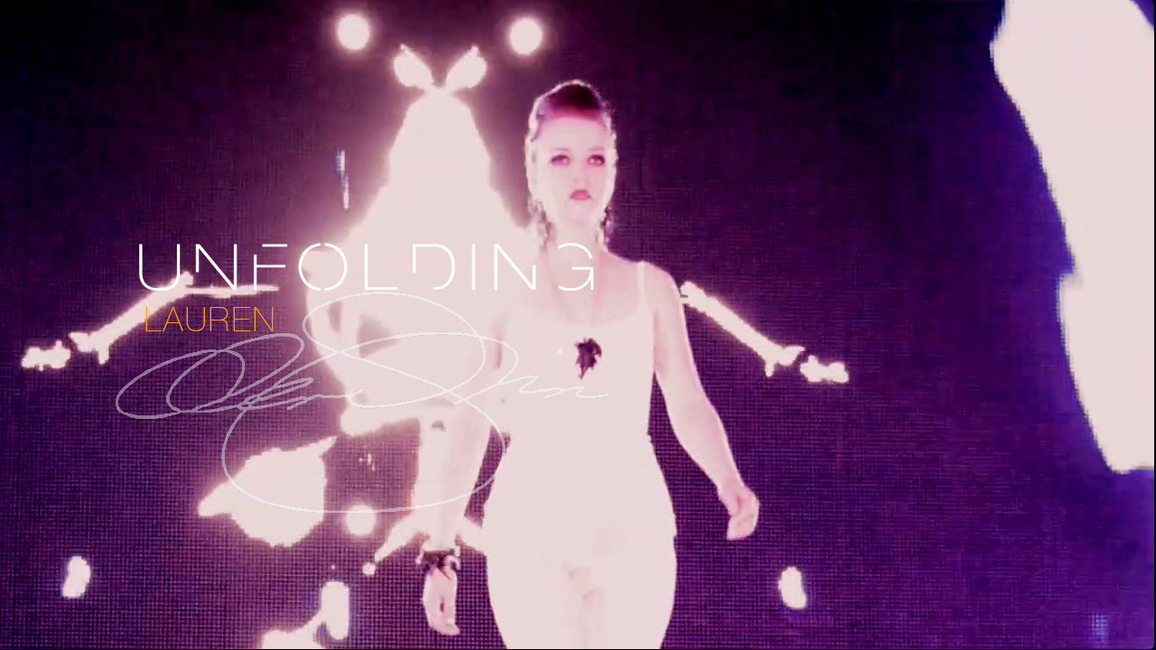 Runway model in a white outfit and statement jewelry walks before a glowing abstract backdrop beneath the title “Lauren Unfolding.”