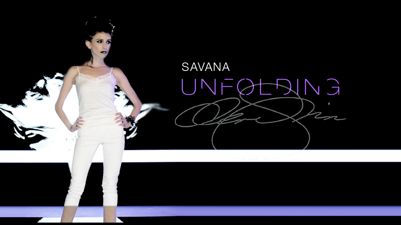 Runway model in a white camisole and cropped pants poses with dark makeup and statement jewelry beneath the title “Savana Unfolding.”