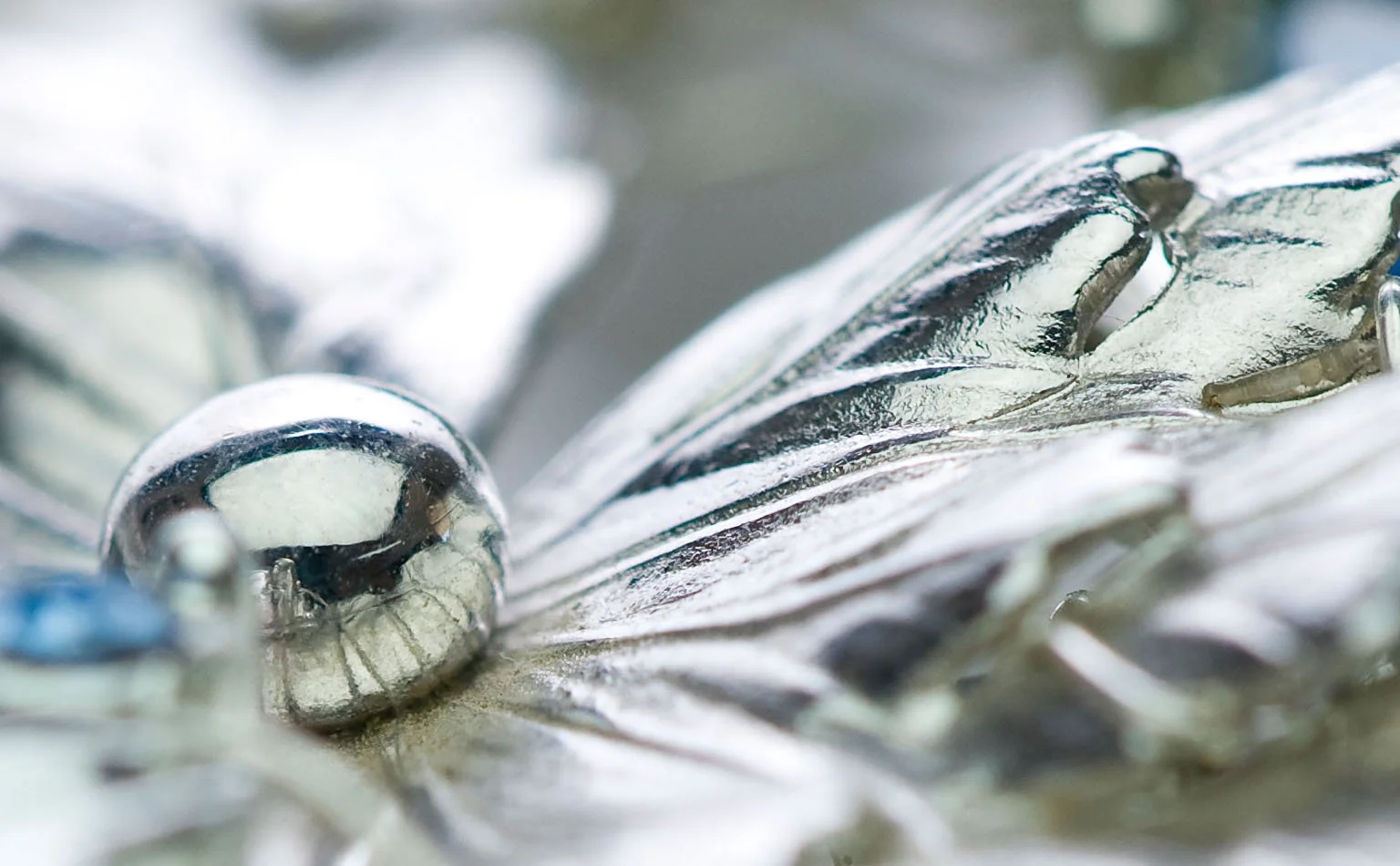 Detail of silver-tone leaf castings on a rhinestone necklace 