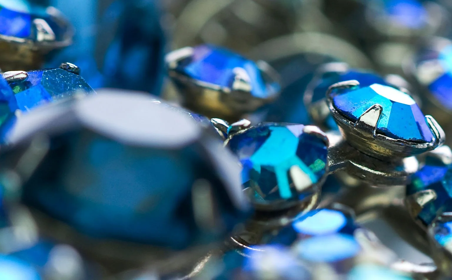 Close macro of blue faceted crystal cut and light refraction 