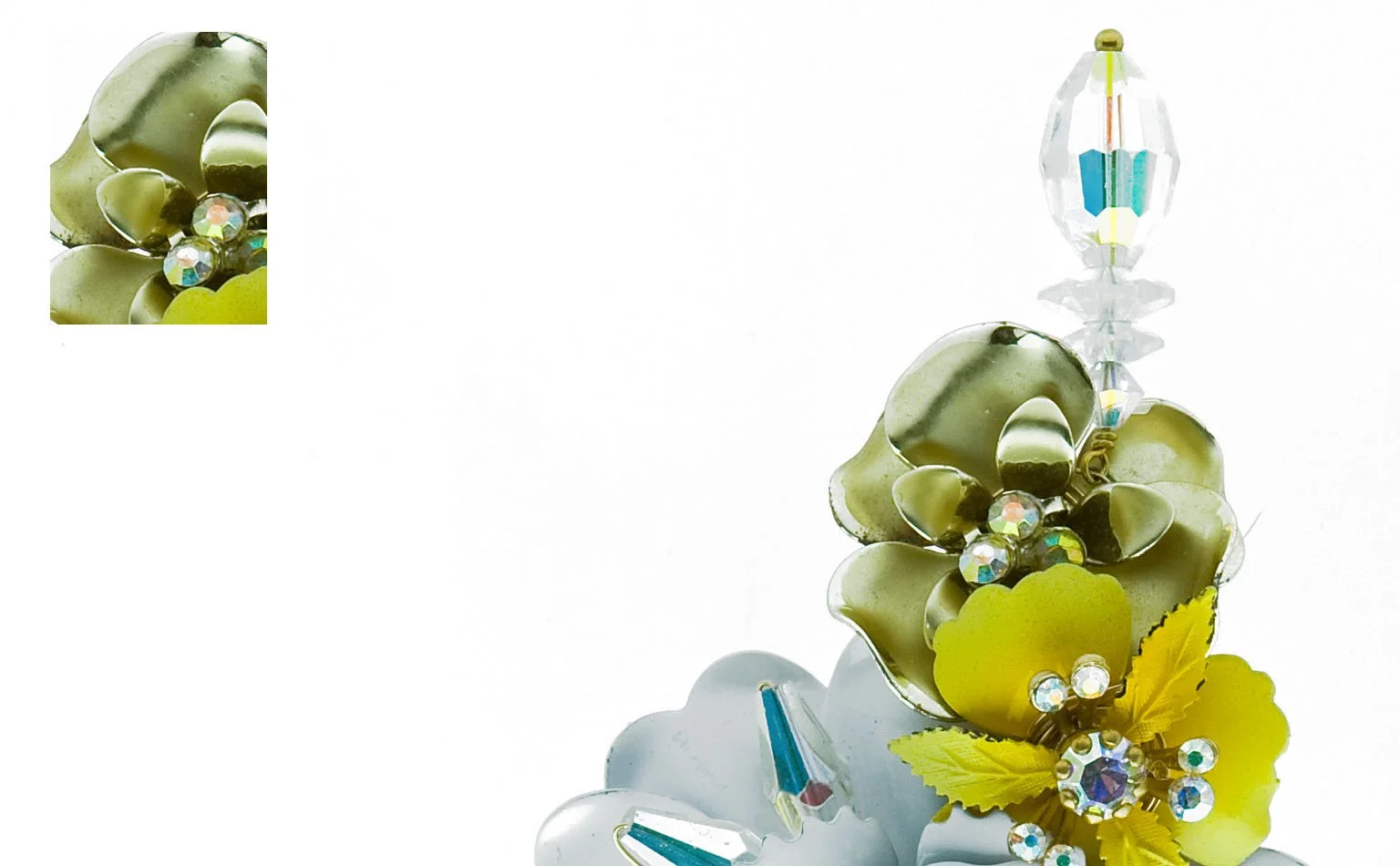 Detail of white and yellow enamel flowers with crystal centers 