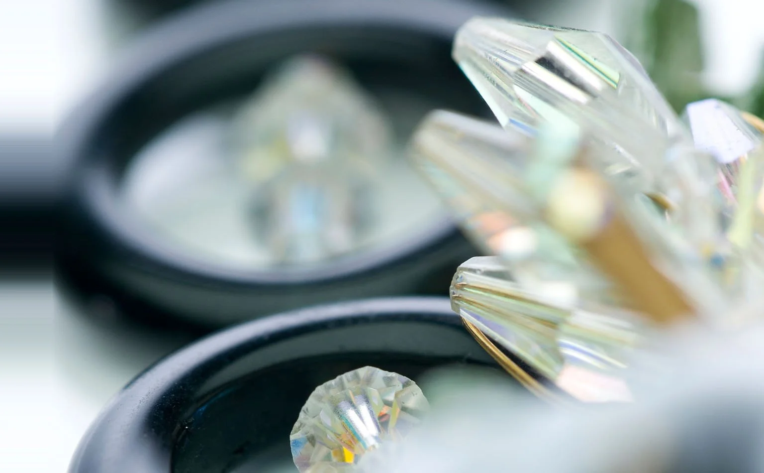 etail of aurora borealis crystal beside black enamel rings 
