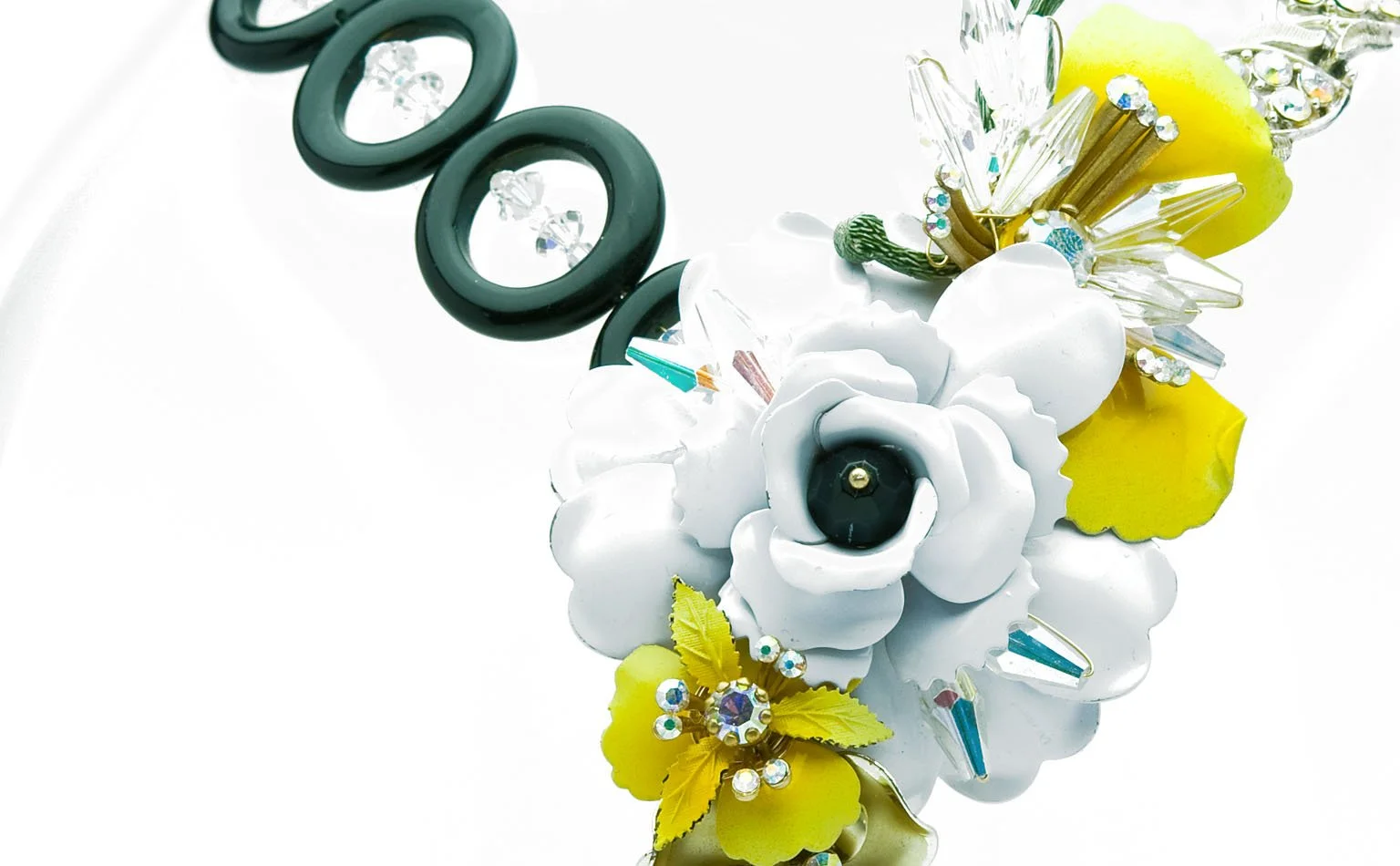 White enamel blossoms and yellow petals along a beaded collar