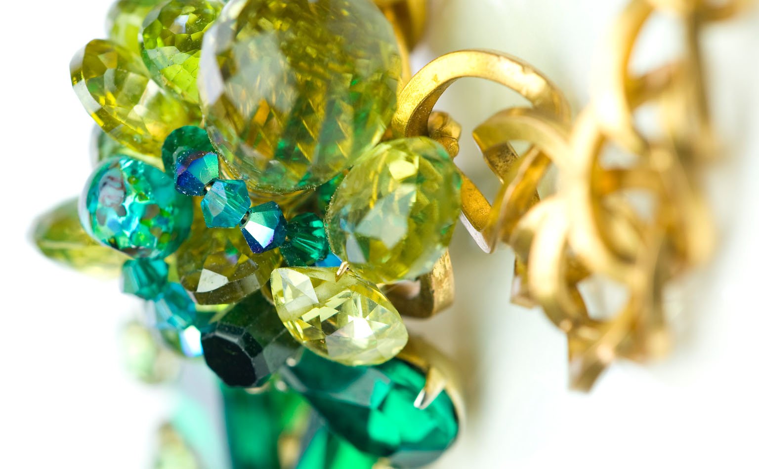 Detail of green and olive crystal clustered over gold leaf castings