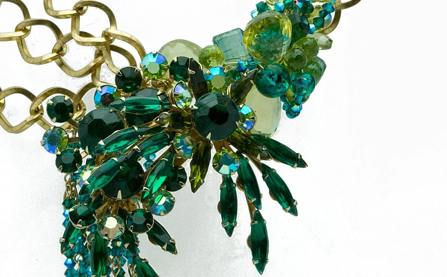Emerald navette crystals and gold chain across the front of a necklace
