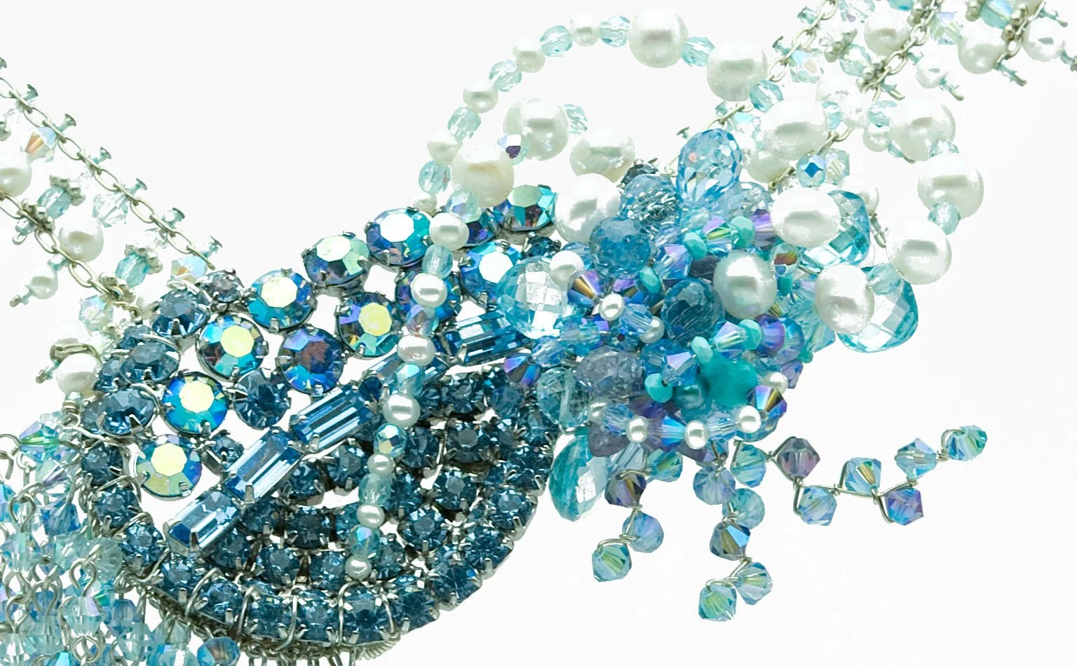 Detail of an aqua crystal and pearl cluster with beaded fringe
