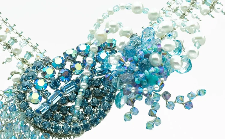 Detail of an aqua crystal and pearl cluster with beaded fringe