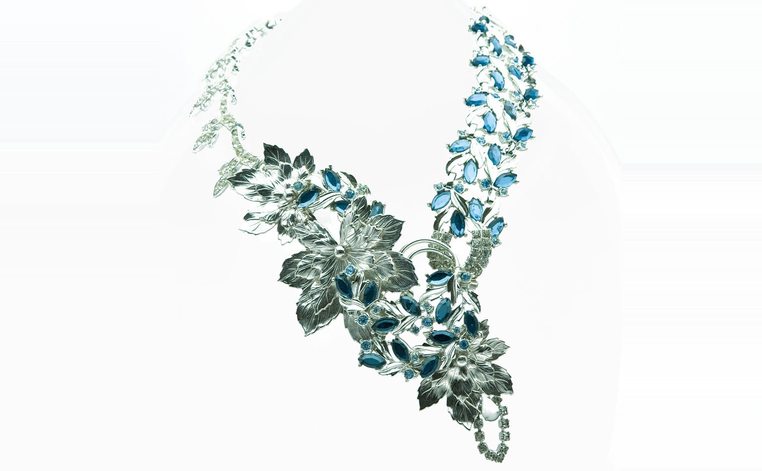 Silver-tone leaf necklace set with blue navette crystal