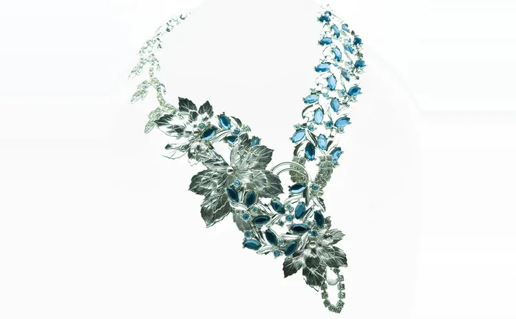 Silver-tone leaf necklace set with blue navette crystal