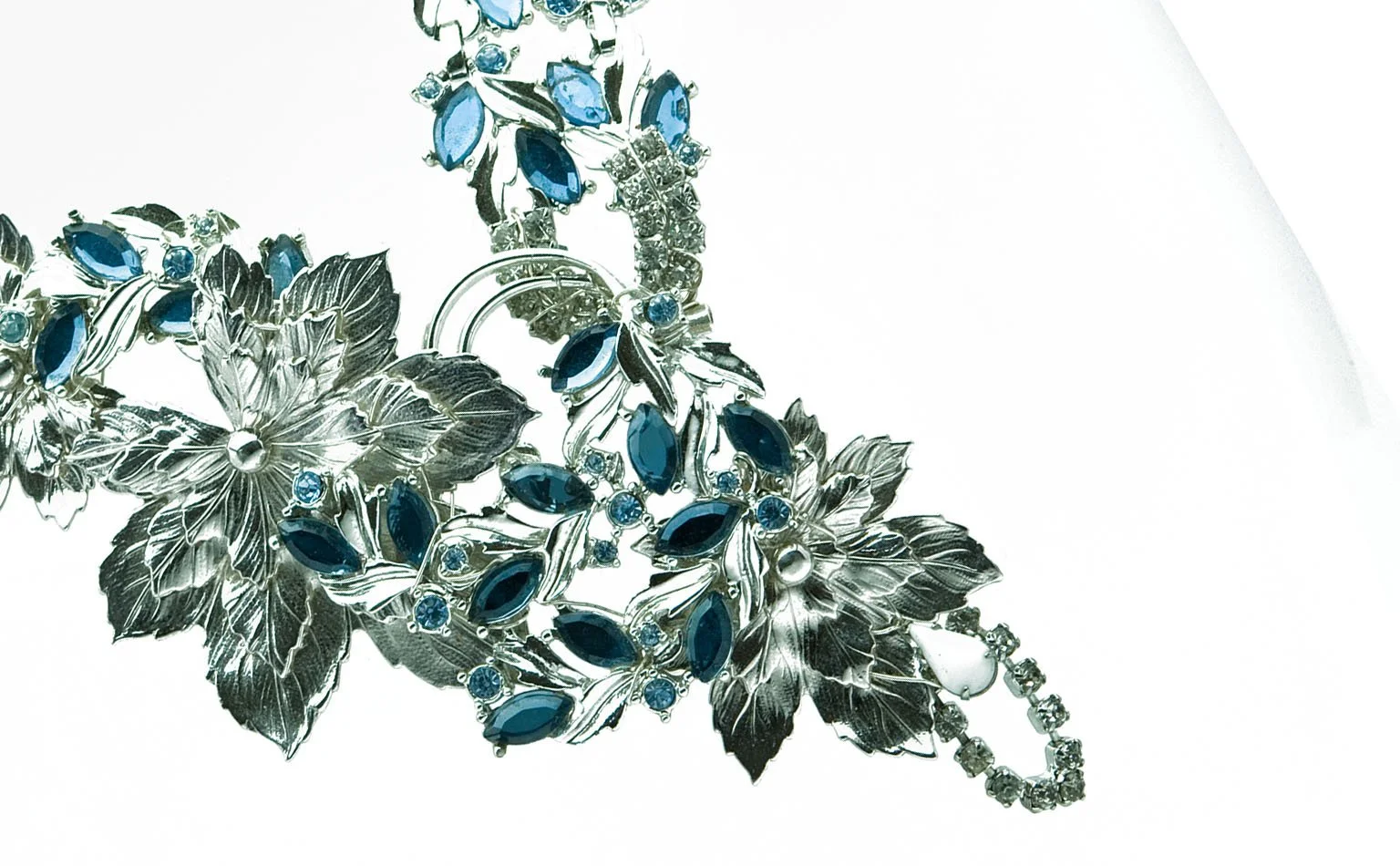 Detail of silver leaf castings and blue navette crystal 