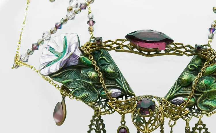 Green enamel leaf necklace centered on a faceted amethyst crystal