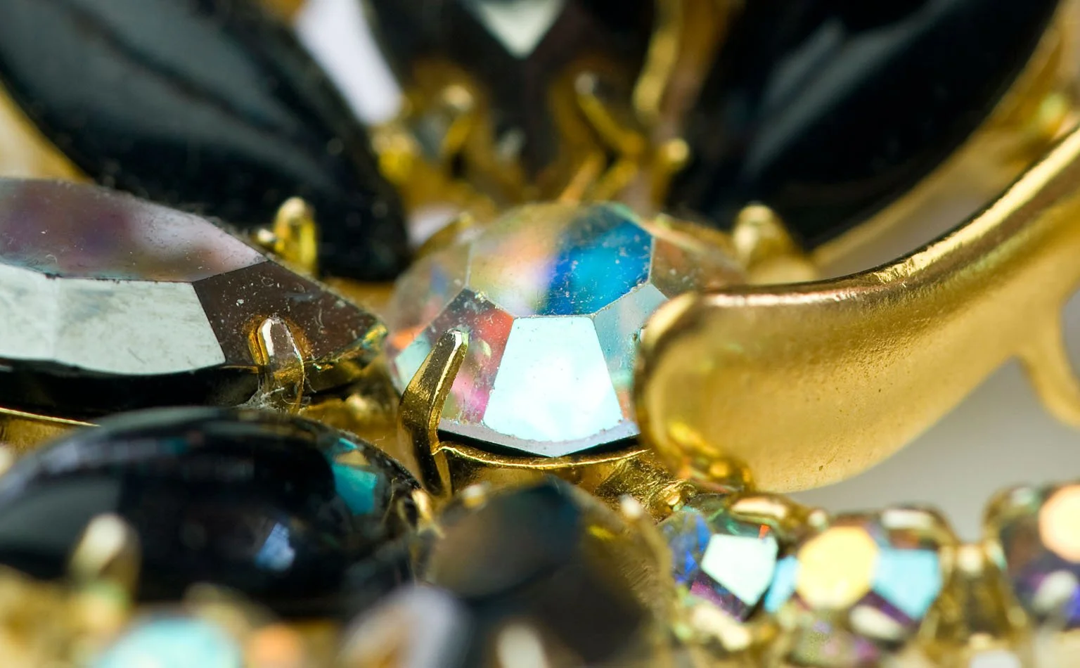 Detail of black faceted crystal and gold-tone leaf castings 