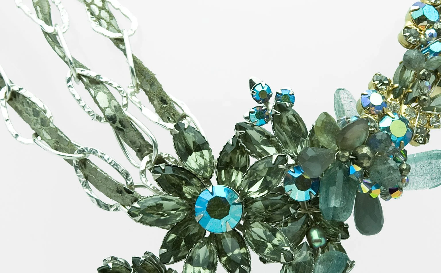 Grey and green crystal petals scattered across a beaded collar 