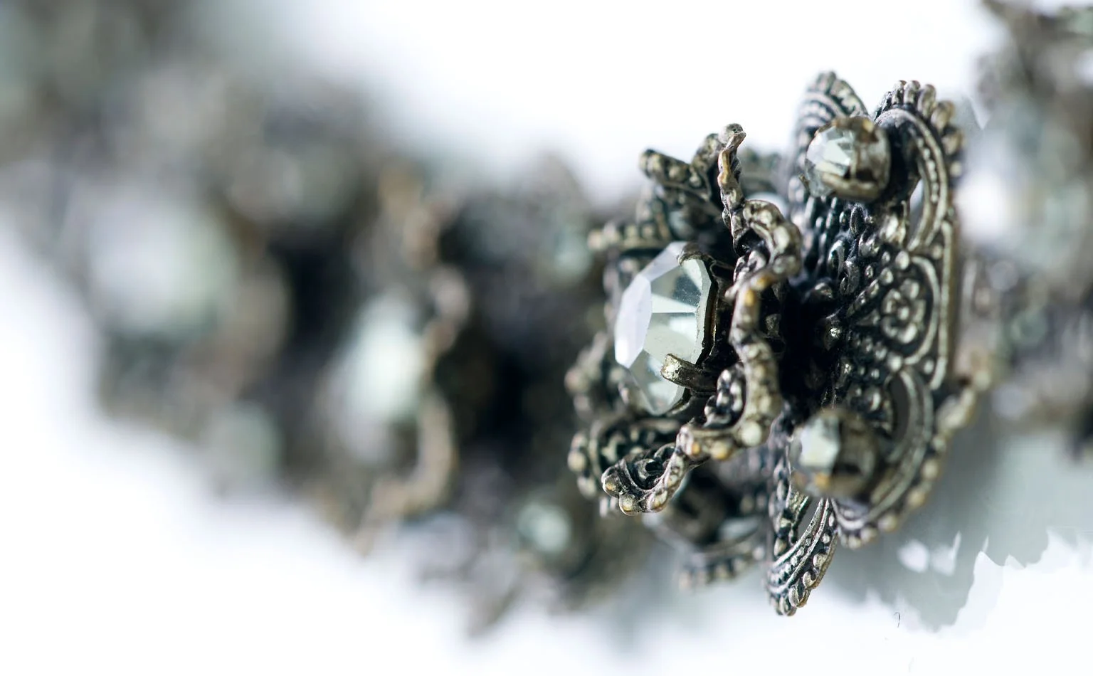 Detail of marcasite filigree set with clear crystal and pearl 