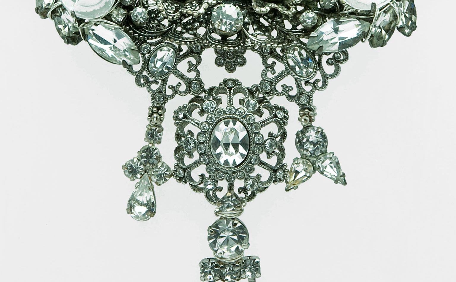 Clear rhinestone pendant with a filigree drop and crystal fringe