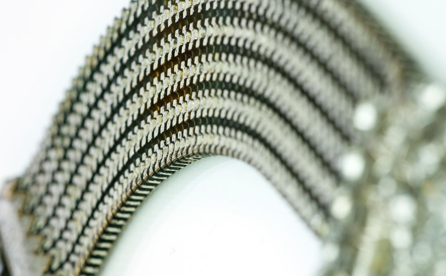 Detail of a fanned multi-row snake chain in silver tone