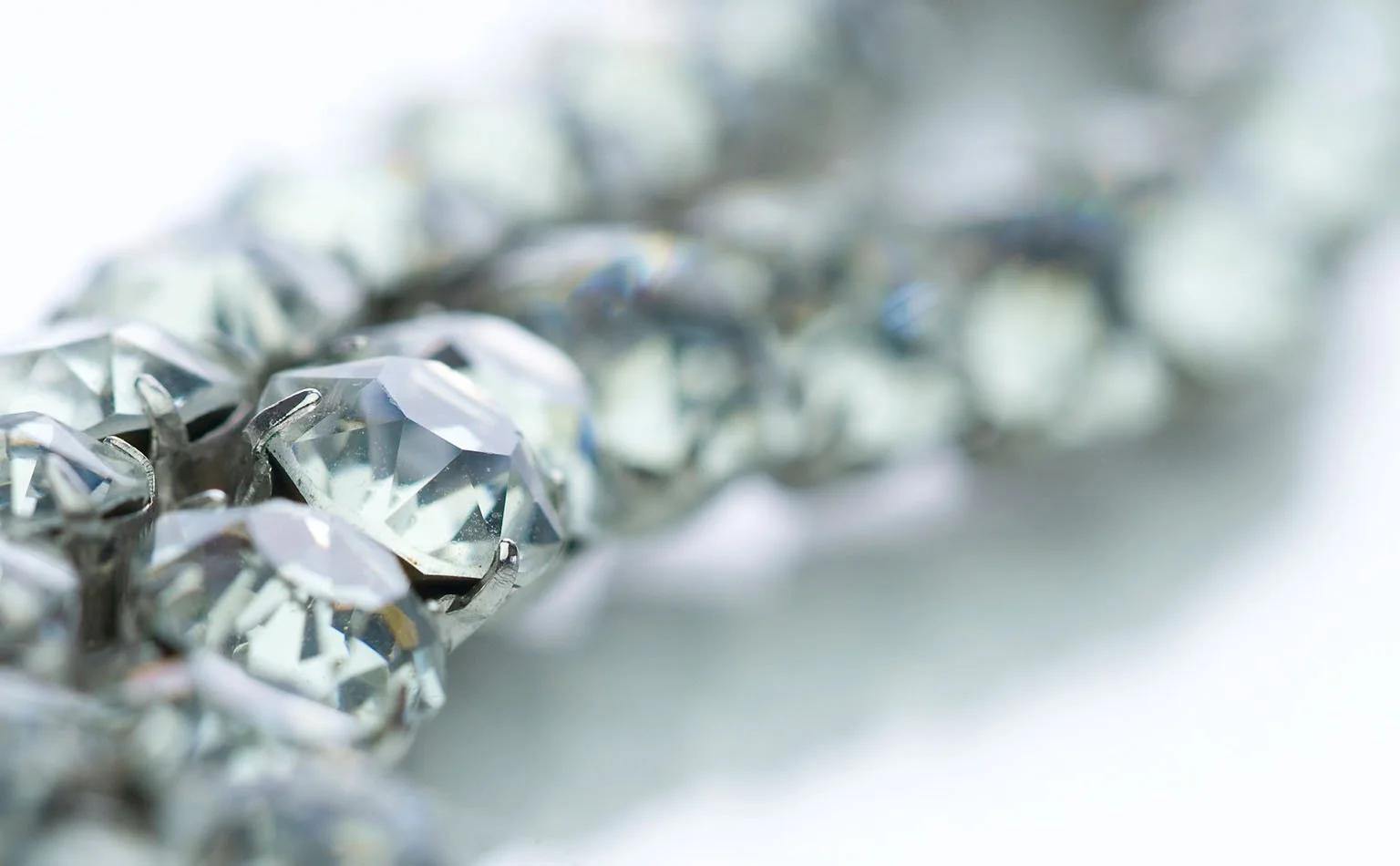 Detail of a rhinestone rope curving through clear crystal