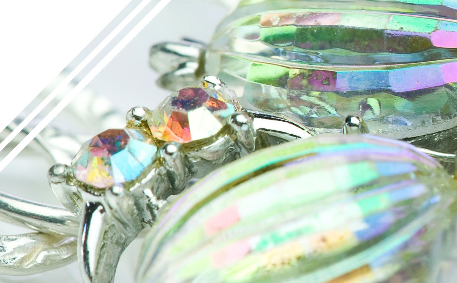 Detail of large iridescent oval crystals in claw settings