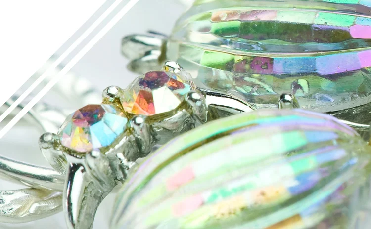 Detail of large iridescent oval crystals in claw settings