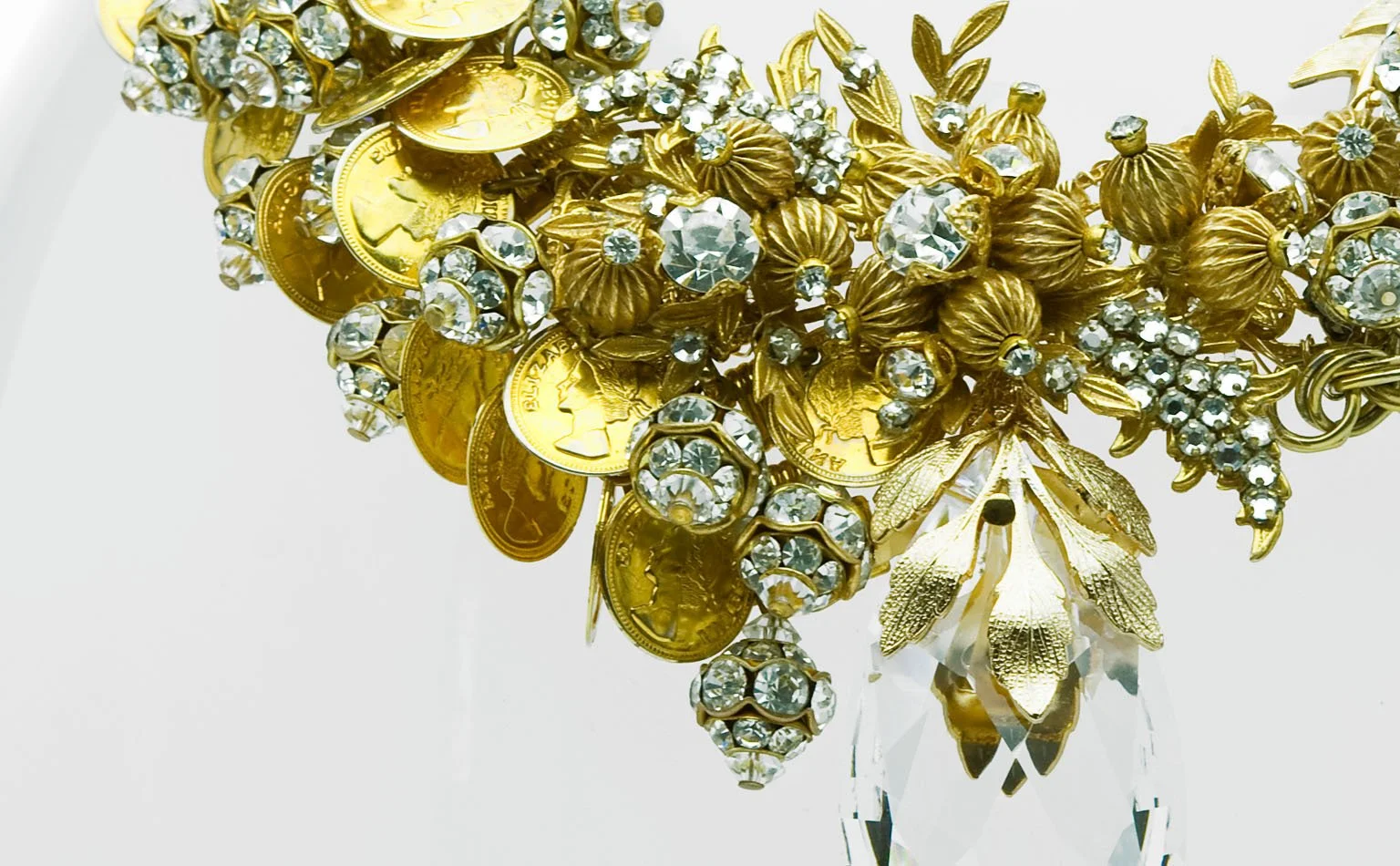 Detail of coin charms, rhinestone flowers and gold leaves on a collar