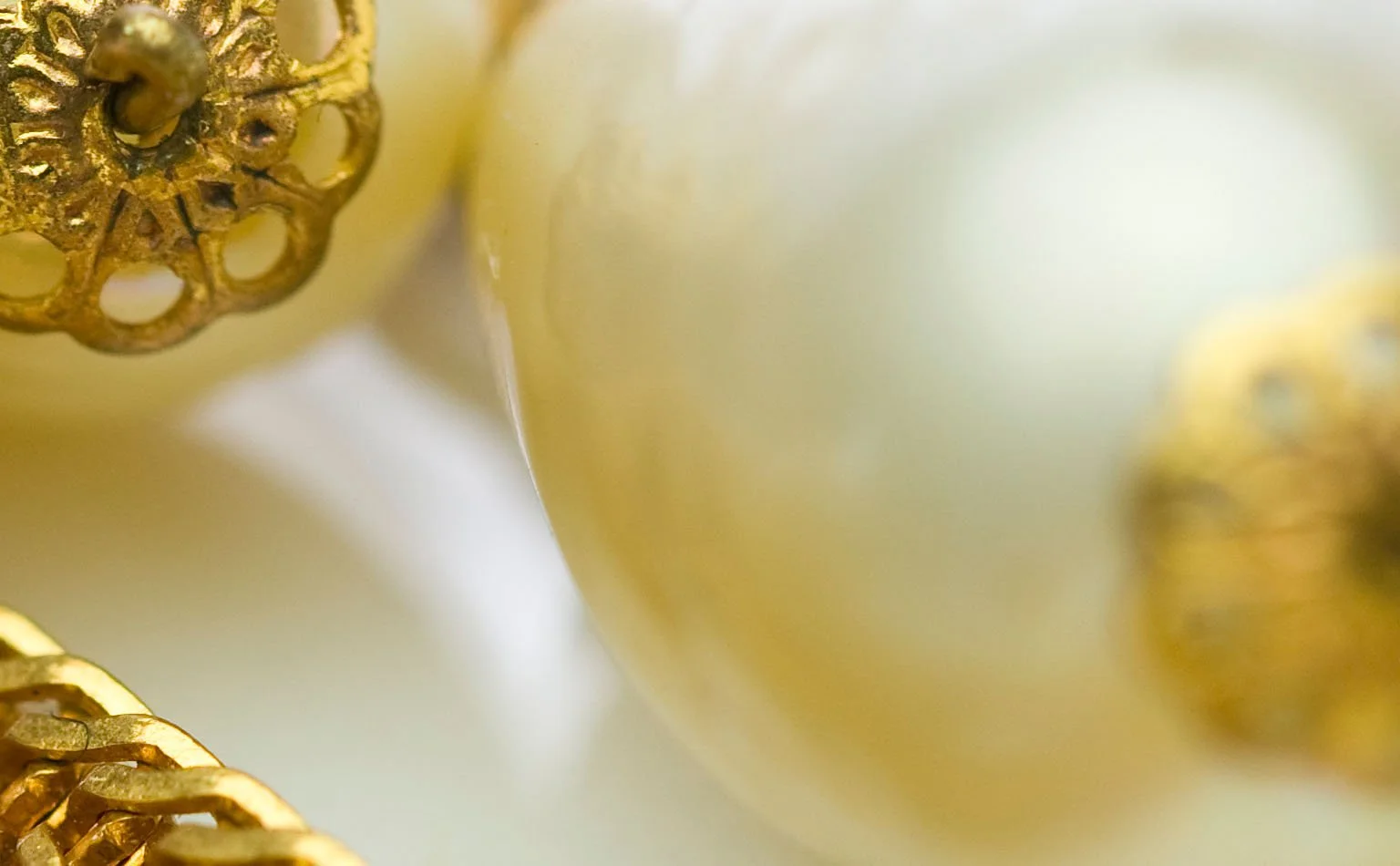 Detail of a large baroque pearl between gold filigree caps 