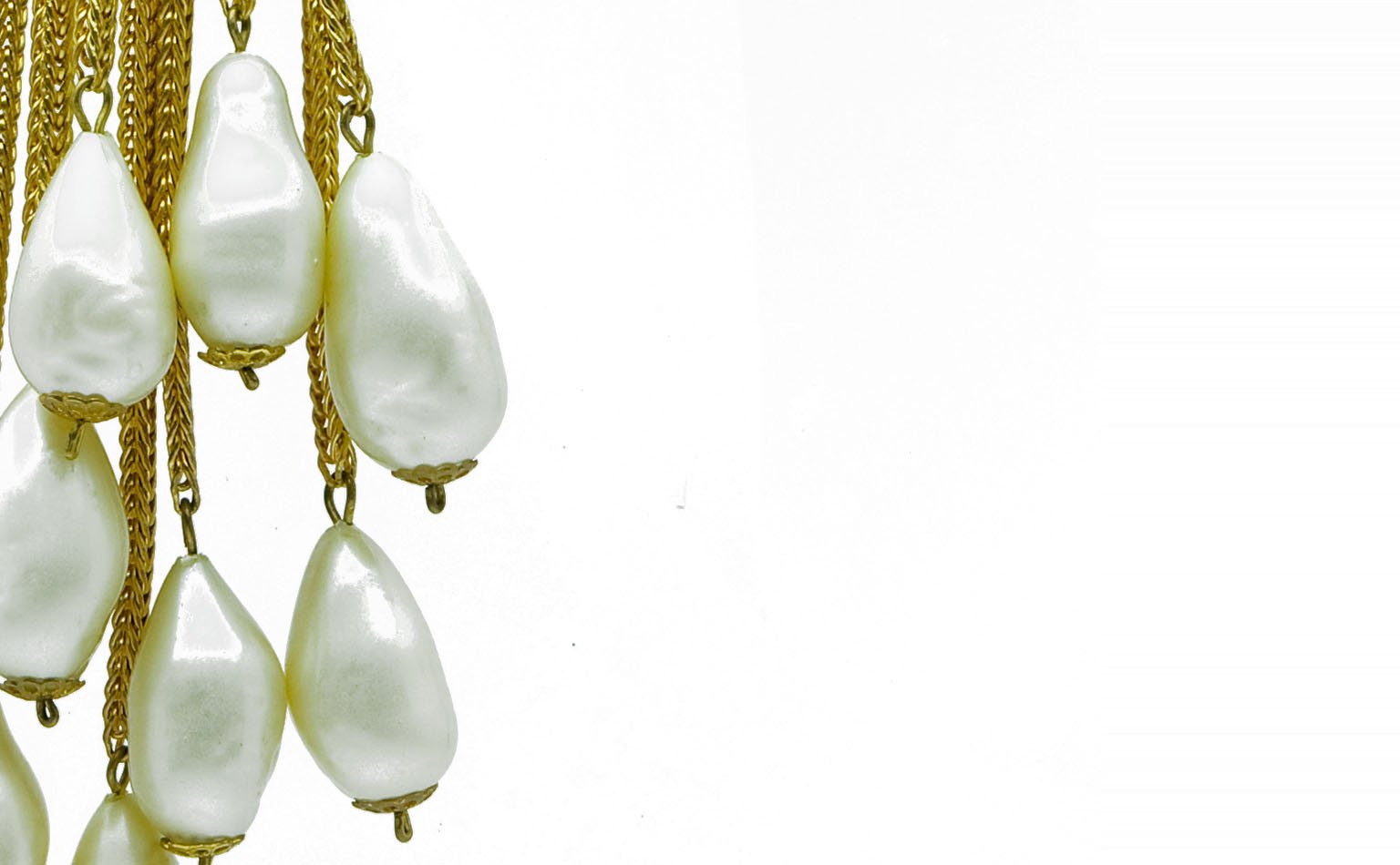 Detail of teardrop pearl drops suspended from gold chain 
