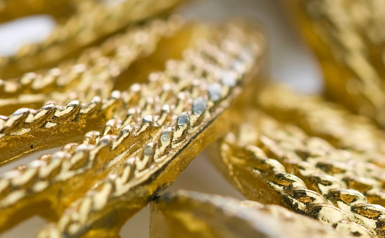 Detail of gold mesh, chain and rhinestone banding layered together