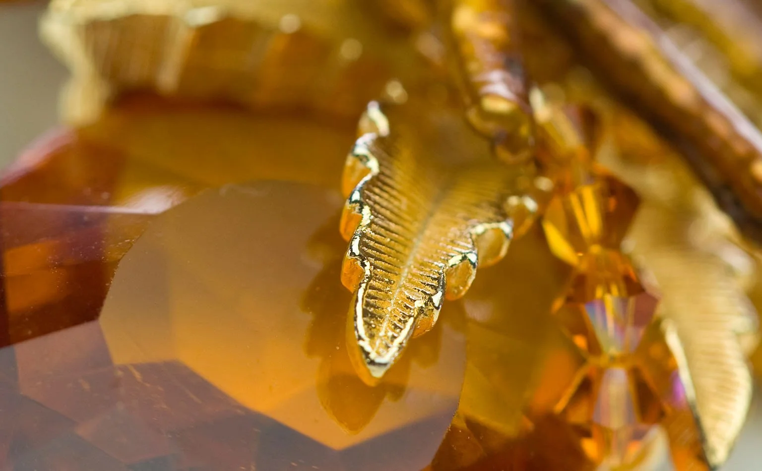 Detail of amber crystal beneath a gold rhinestone rope 