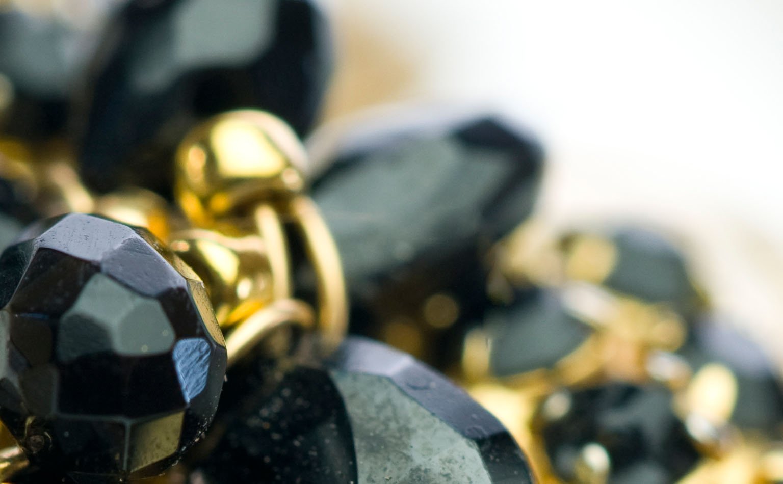 Detail of faceted black jet beads with gold accents