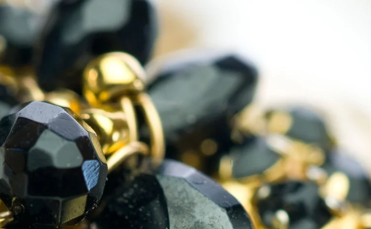 Detail of faceted black jet beads with gold accents