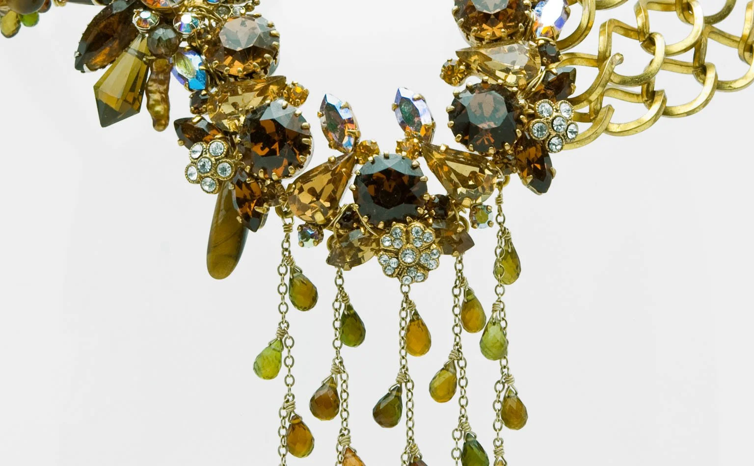 etail of olive and amber crystal above a chain fringe 