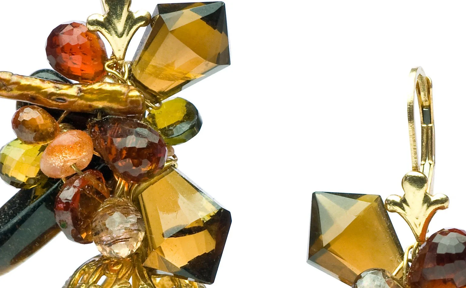 Detail of amber and topaz crystal clustered on a gold earring