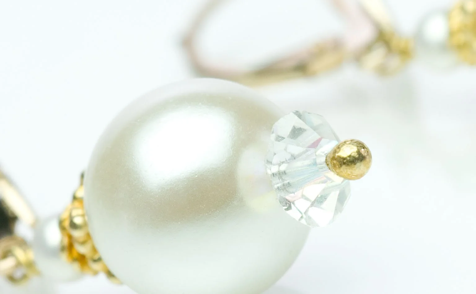 Detail of a pearl drop earring with a crystal spacer 