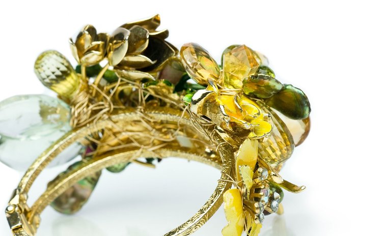 Gold cuff bracelet with yellow and green enamel flowers