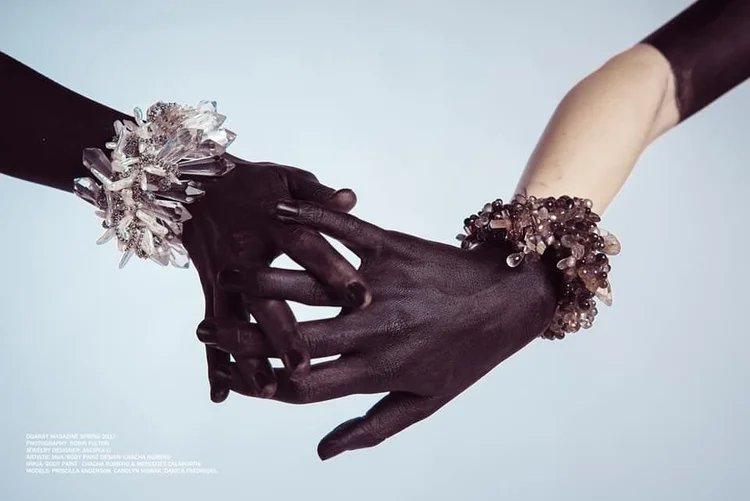 DGARAY, Timeless Beauty, credit page: two clasped hands wearing Andrea Li crystal and smoky quartz cluster cuffs