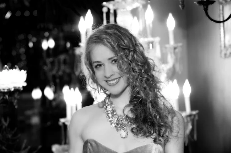 Black and white landscape: the curly-haired model among chandeliers