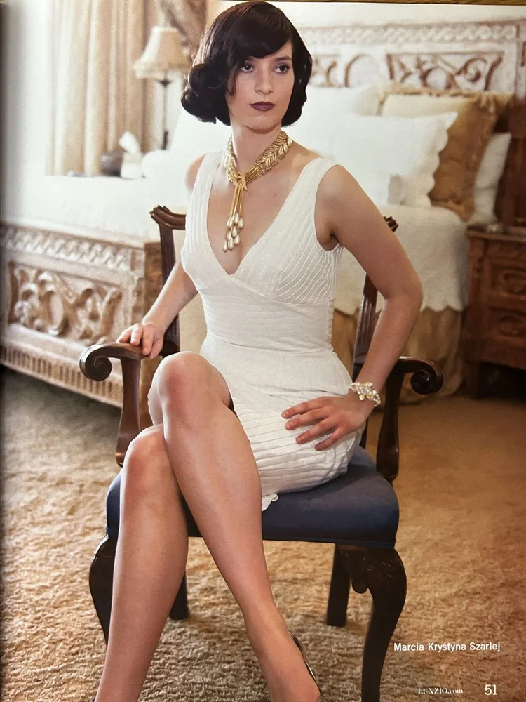 LUXZIO page 51: Marcia Krystyna Szarlej in a white dress wearing an Andrea Li gold necklace